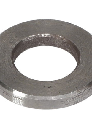 A close-up image of the AGCO | CHANGE VALVE - F842960200020 washer, showcasing its smooth, circular shape and a large central hole. The slightly rough texture of the metal washer is prominently displayed. Please note: No current product description information is available.