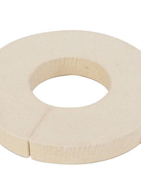 The AGCO Felt Seal - Acw1790510 is a round, beige felt washer featuring a central hole and a small slit on one side; additional details are currently unavailable.