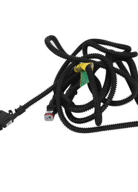 The AGCO Harness - Acw0605250 is a coiled black electrical wiring harness featuring connectors at both ends, some labeling, and a yellow tag.