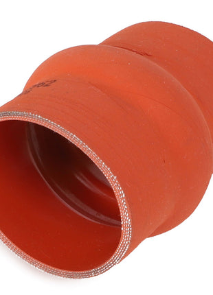 The AGCO HOSE - AG121551 is a red silicone hose reducer with a smooth outer surface and reinforced inner lining, designed for maximum durability in connecting pipes of different diameters within engine compartments for automotive or industrial applications. Ideal as a replacement for AGCO hoses.