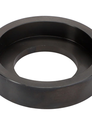 The AGCO Tool - Act0012370 is a circular, black metal object featuring a flat outer ring and a hollow center, similar in appearance to a large washer or gasket. No current product description is available for this part.