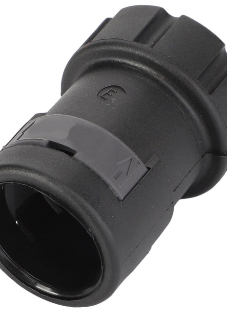 A black plastic cylindrical connector cover with grooved edges and an arrow indicating direction; product information for the AGCO Connector Cover - D45010038 is currently unavailable.