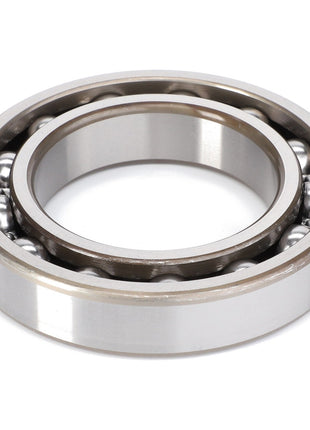 The AGCO Ball Bearing - F514300020210 features an inner and outer ring with several small metal balls in between, designed to manage rotational friction efficiently while accommodating both radial and axial loads.