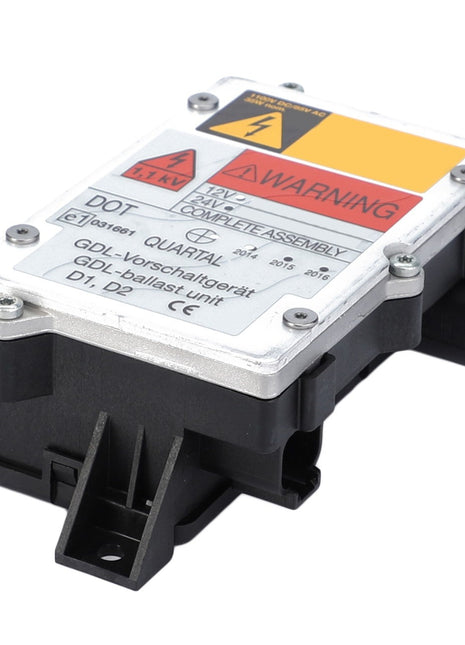 Close-up of the AGCO Electrical Ballast - F931901111010 unit, displaying a warning label, connection ports on one side, and a metallic casing with printed details on the top. No current product description available.