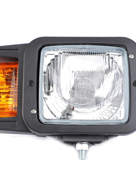 Close-up of an AGCO Genuine Headlight, Right - E400048 featuring a rectangular design with a clear lens in the center and an orange lens on the left side, all mounted in a black housing. This AGCO headlight is crafted for optimum fit, ensuring durability and reliability.