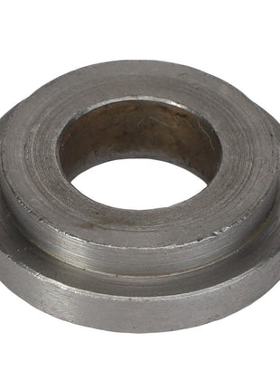 The AGCO | SPACER - AG059177 is a round metal washer with a central hole, featuring a slightly grooved surface.