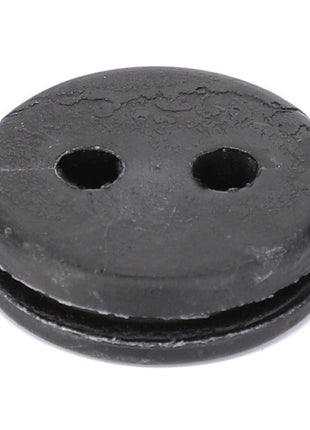 A black, round rubber mounting from AGCO (F100003361809) featuring two holes and a distinct groove encircling its circumference.