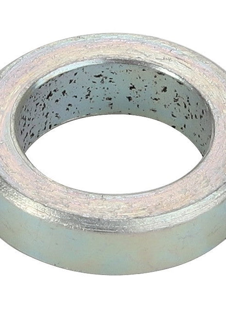 The AGCO | SPACER - CH202-9701 by AGCO is a metal gasket with a cylindrical shape, featuring a hollow center and a surface speckled with dark spots. No current product description information is available.