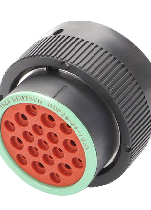 Close-up image of an AGCO Connector Plug - AG521001, a black circular device with green and red detailing, showcasing numerous small connection points on one end. No current product description information is available.