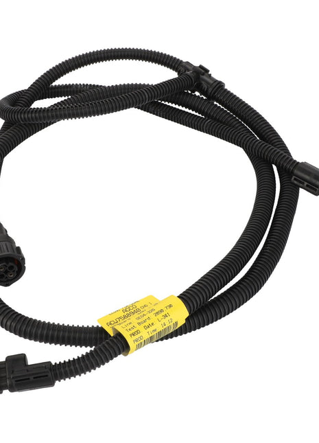 A coiled black wiring harness with connectors at both ends and a yellow label attached in the middle, known as the AGCO Harness - Acw7588940 by AGCO. No current product description information is available.