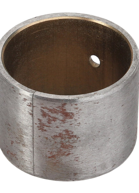 The AGCO BUSH - ACY1514130, a cylindrical metal bushing from the AGCO brand, features a small hole and a slightly worn, tarnished surface, reflecting its status due to the lack of current product description information.