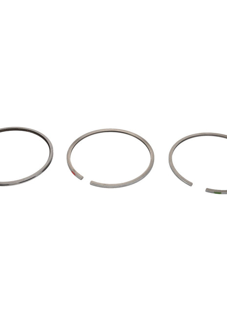 Three AGCO | Piston Ring, Kit - Acp0210040 sets of differing designs are showcased in a row against a plain white background, demonstrating their function in engine lubrication and sealing combustion gases.