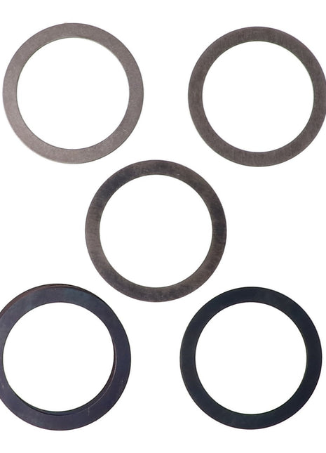 Using five circular metal washers from the AGCO Shim Kit - Acp0360610, the arrangement is in the shape of a plus sign.
