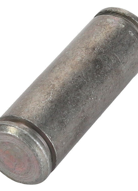 A close-up of the AGCO BOLT - F716501030760, a cylindrical metal pin or dowel, slightly weathered and rough-textured, evocative of components found in classic Fendt models.