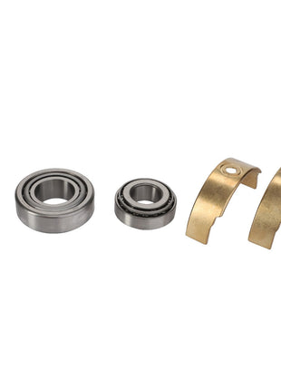 Image of the AGCO Bearing Kit - F930940010060, featuring metal washers, bearings, and brass half shells precisely aligned in a singular row on a pristine white background.