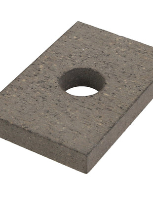 A rectangular black metal plate with a single circular hole in its center, viewed from an angle. This item is the AGCO | BRAKE LINING - D28980605. No additional product description information is available for further details.