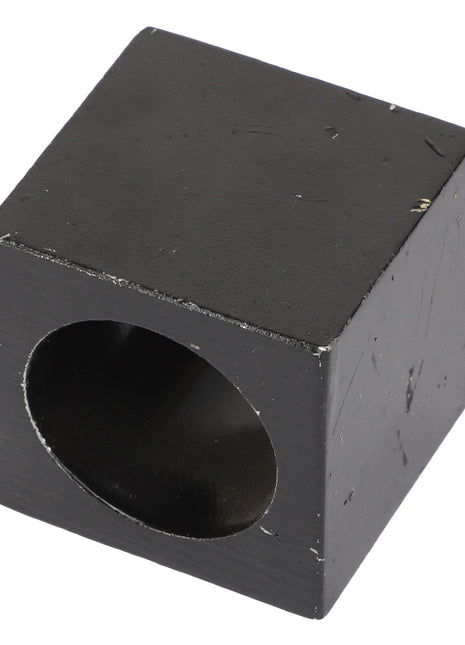 A black cubic object with a cylindrical hole passing through its center; currently, no product description information is available for the AGCO | SLEEVE - AL330214 by AGCO.