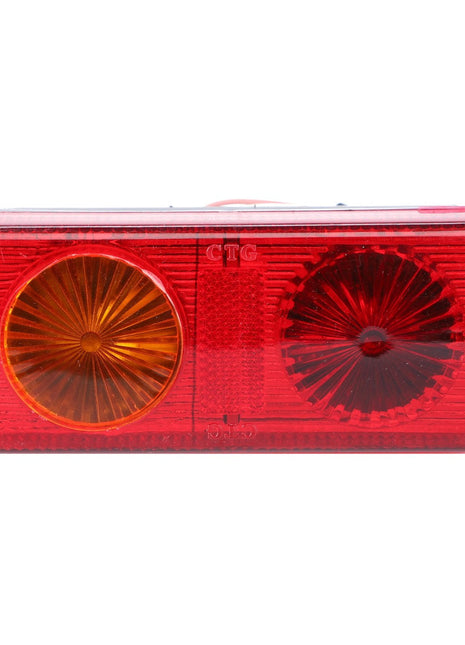 Product Data: The AGCO Combination Light, Rear - Acp0209600 features a rectangular tail light assembly with two circular lenses—one amber and one red—encased in a durable red plastic housing. Designed for tractors, this AGCO Genuine Rear Light enhances safety and visibility both on the road and in the field.