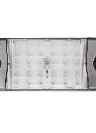 The AGCO Combination Light - 6317364M1 is a rectangular LED light fixture featuring a transparent cover, black side accents, and a ribbed design that reveals the visible LED components inside. The markings "9050" and "Made in New Zealand" are stamped on it. Ideal for tractor illumination, this product guarantees the reliability and performance synonymous with AGCO Genuine Rear Lights.