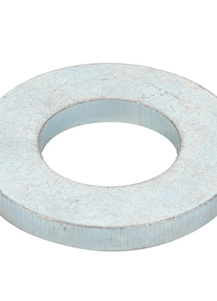 The AGCO | SPACER - D20400522 by AGCO is a durable metallic washer with a circular hole in the center, ideal for various fastening applications.
