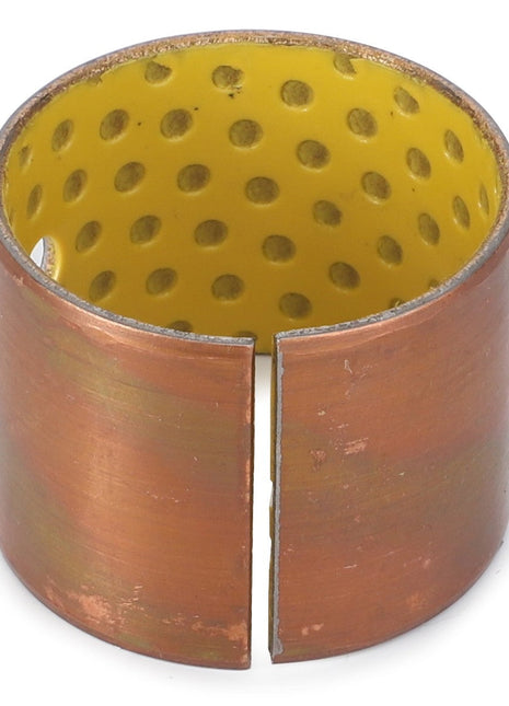 The AGCO | BUSH - AL5018517 from AGCO is a cylindrical, copper-colored original bushing featuring a yellow, perforated interior and a visible side slit designed for front loaders.