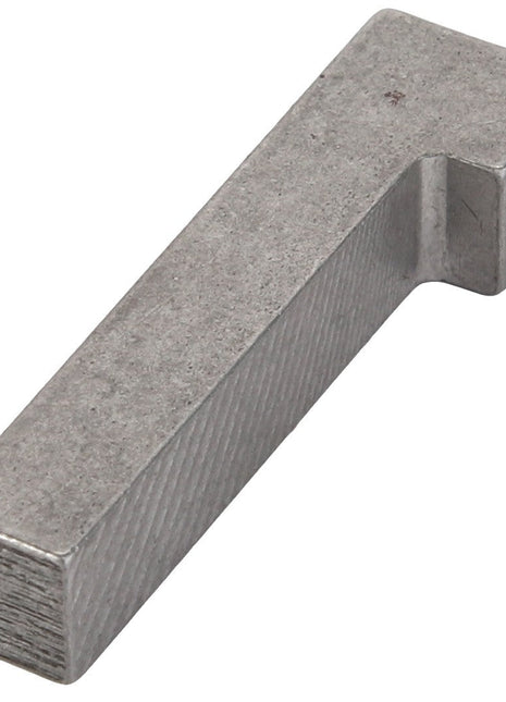 The AGCO GIB KEY - D26732728 is a metallic rectangular tool featuring a slight angle near one end, appearing to be made of steel or a similar metal.