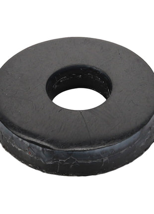 A black rubber washer with a central hole, appearing slightly worn around the edges. This item is branded as AGCO and has the product name Bush - Acx0096350. No current product description information is available.