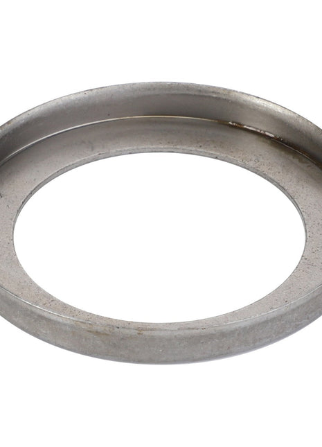 A close-up of the AGCO Retaining Sheet Metal - F184300020350, a metallic circular ring with a hollow center, shimmering under the light.