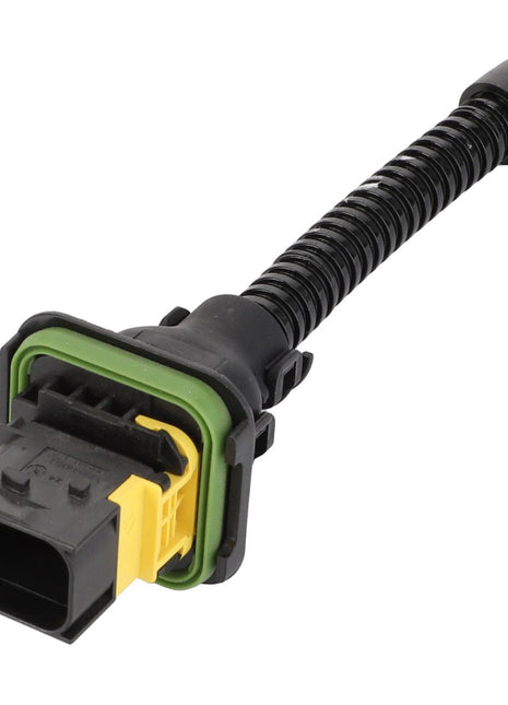 AGCO's Adapter Cable, Engine, 12 V - Acp0408450 is a black automotive electrical connector featuring a yellow and green seal connected to a coiled black wire, ensuring operating safety with the reliable performance of AGCO Parts Genuine Electrics.