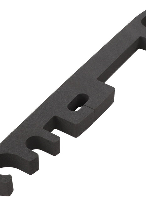 A black plastic bracket with four hook-like cutouts and a rectangular hole in the middle. This item is identified as the AGCO Seal - Acw136617A by AGCO.