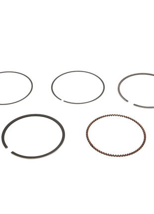 Displayed against a white background are five distinct AGCO rings, part of the "KIT, RING - ATV3402-266" collection. Four of these metal rings are flat and solid, while one features a unique beaded texture. Currently, no additional product description information is available.