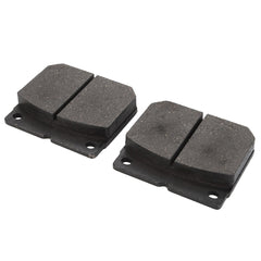 Two dark-colored automotive brake pads, identified as AGCO LA312969000 and rigorously proven through laboratory testing, are shown side by side against a white background.