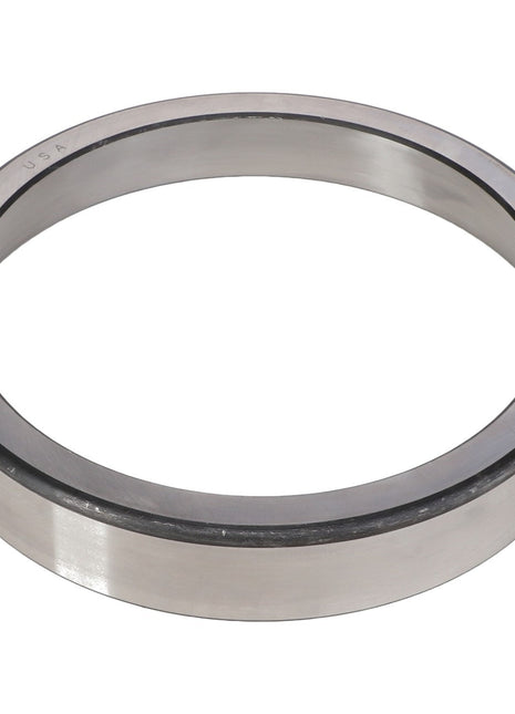 The AGCO | BEARING CUP - AG711901, a metallic, circular bearing ring with a smooth, reflective surface, is likely designed for handling radial loads in machinery or automotive applications.