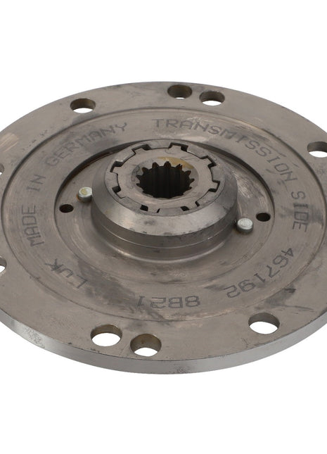 Circular metallic component labeled "Made in Germany" and "Transmission Side" with bolt holes around the perimeter and a central spline, identified as AGCO | Damper - Acp0333090 by AGCO. *No Current Product Description Available.*