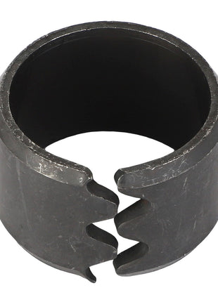 Introducing the AGCO Tension Bushing - Acp0015600, a cylindrical metal bushing with a split and textured surface, designed with two interlocking notches at the opening.