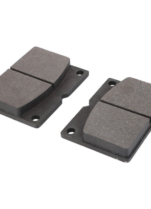 The AGCO Pair of Pads - La321981400 features two black brake pads with grey friction surfaces, each equipped with two mounting holes. As genuine AGCO Parts, these pads have been rigorously tested to guarantee optimal performance.