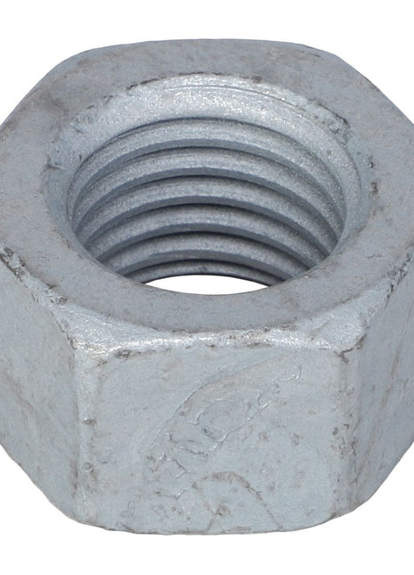 A close-up view of an AGCO | HEX NUT - CH8T-4001 reveals intricate internal threading.