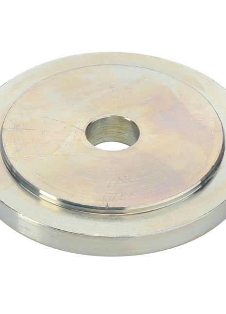The AGCO | Special Washer - Acx0032090 by AGCO is a round, flat metal washer featuring a central hole. The surface has a slightly reflective, light metallic finish. Detailed specifications and usage information are currently unavailable.