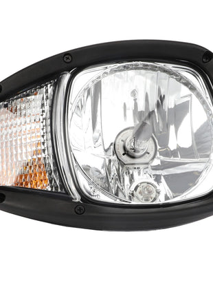 Close-up of the AGCO WARNING DECAL - ACP0538090 headlight, featuring a clear lens with a black frame, reflective surface, and amber-colored section, ensuring optimum illumination for superior visibility.