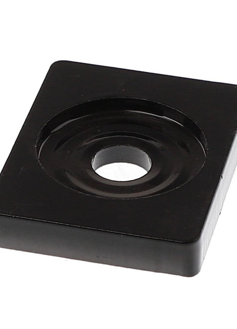 The AGCO | Spring Retainer Plate - Acp0013170 is a black, square rubber foot featuring a central hole for mounting. This slightly elevated component includes a circular indentation around the hole for added functionality. While there is no current product description available, it stands out as a simple yet effective solution.