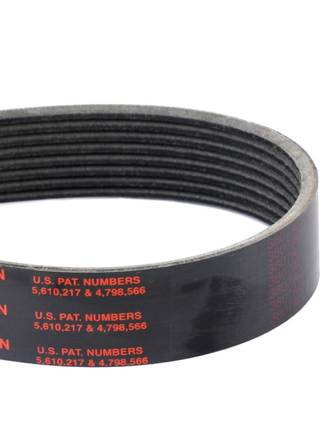 Close-up of the AGCO Genuine Serpentine Belt, Pk8 Profile - A3288911V, featuring a black ribbed design with red text indicating it is made in the USA and listing US patent numbers 5,610,217 and 4,798,566. This belt is engineered to enhance engine performance while minimizing noise and slippage.