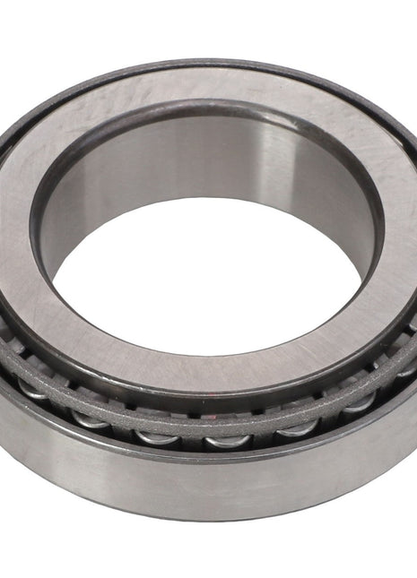 The AGCO Bearing Set - Acp0287130 is a metallic cylindrical tapered roller bearing featuring an open center and visible small cylindrical rollers, designed for mechanical applications to minimize friction and support both radial and axial loads. This product currently does not have an available description.